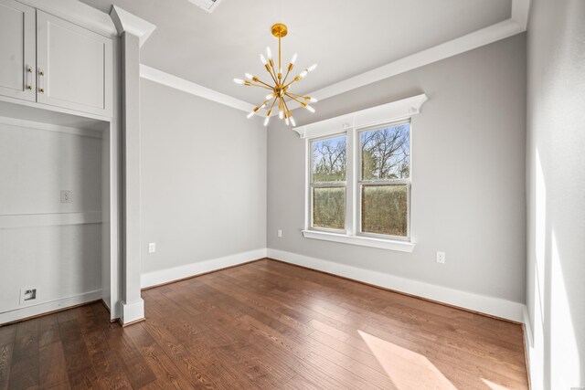 unfurnished bedroom with dark wood-type flooring, crown molding, baseboards, and an inviting chandelier