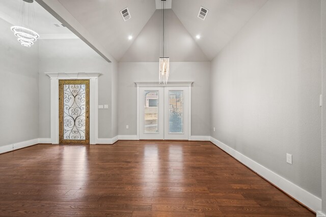 foyer entrance with baseboards, dark wood-type flooring, visible vents, and an inviting chandelier