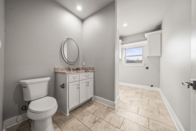 bathroom with baseboards, vanity, toilet, and tile patterned floors