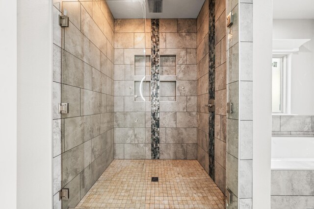 bathroom featuring a stall shower and visible vents