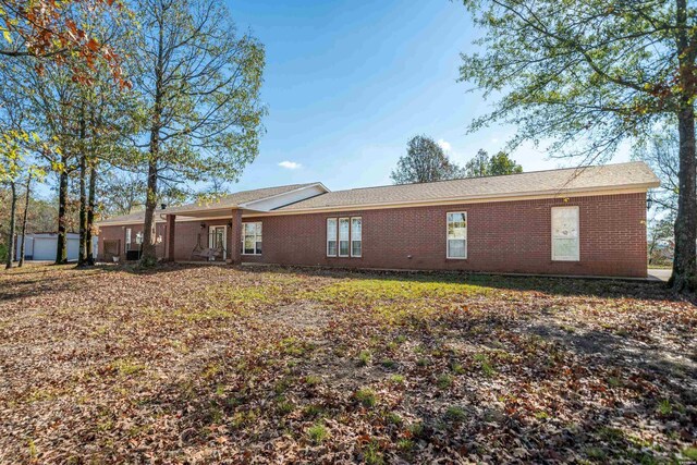 back of house featuring brick siding