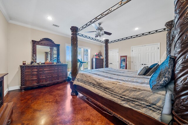 bedroom featuring baseboards, visible vents, crown molding, concrete flooring, and multiple closets