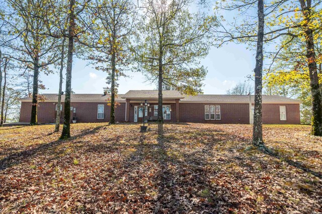 ranch-style house featuring brick siding