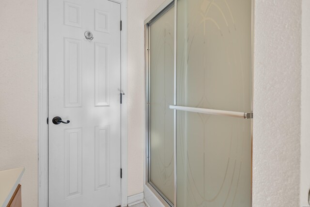 bathroom featuring a stall shower and vanity