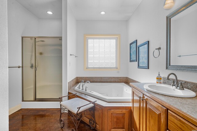 bathroom featuring a tub with jets, a stall shower, vanity, and recessed lighting