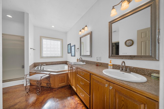 bathroom featuring a garden tub, a shower stall, concrete flooring, and a sink