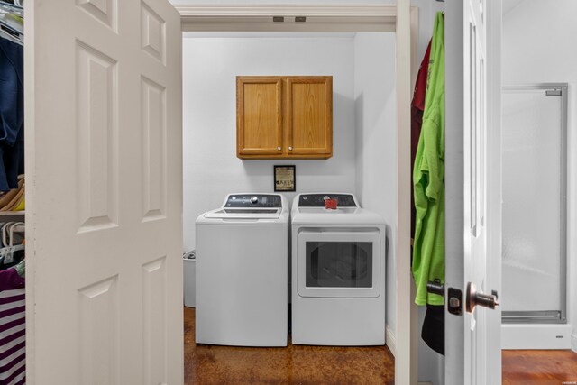 washroom with cabinet space and independent washer and dryer