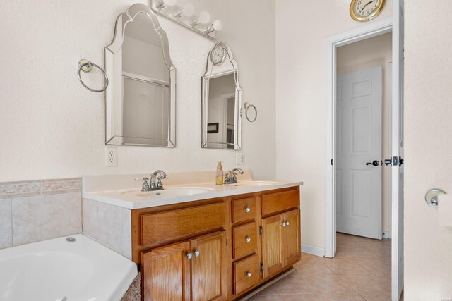 full bathroom with a garden tub, double vanity, tile patterned flooring, and a sink