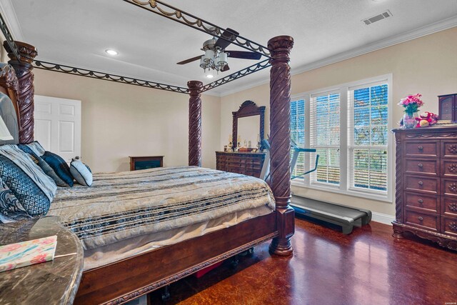 bedroom featuring baseboards, finished concrete floors, visible vents, and ornamental molding