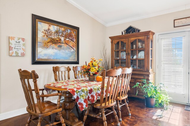 dining space featuring dark wood-style floors, crown molding, and baseboards