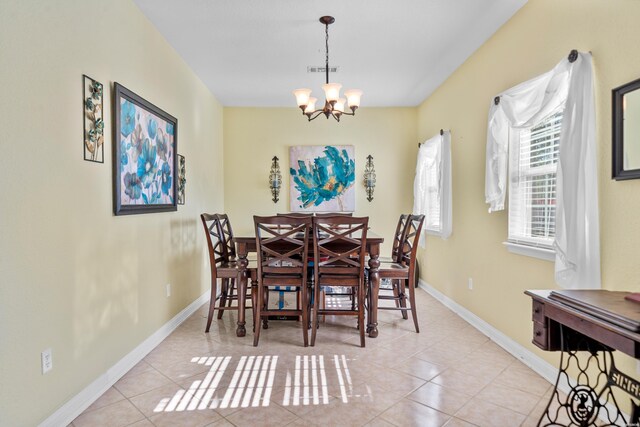 dining room featuring visible vents, a notable chandelier, baseboards, and light tile patterned floors