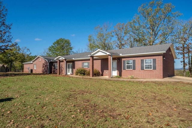 ranch-style home featuring brick siding and a front lawn