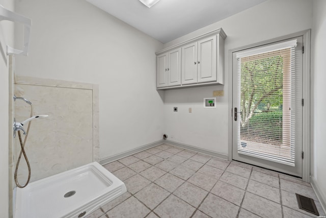 clothes washing area with cabinet space, baseboards, visible vents, hookup for an electric dryer, and washer hookup