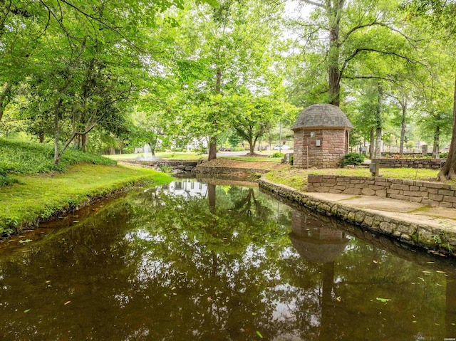 surrounding community with a water view and a gazebo