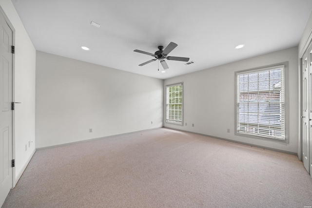 spare room featuring visible vents, baseboards, a ceiling fan, light colored carpet, and recessed lighting