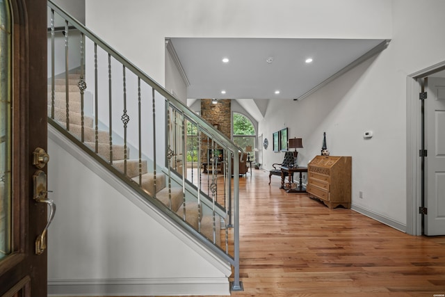 entrance foyer with stairs, baseboards, wood finished floors, and recessed lighting