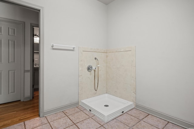 full bath with a stall shower and tile patterned floors