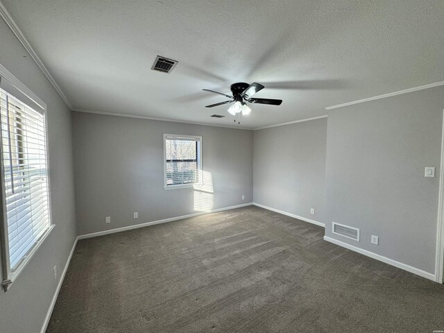 spare room featuring visible vents, a textured ceiling, and ornamental molding