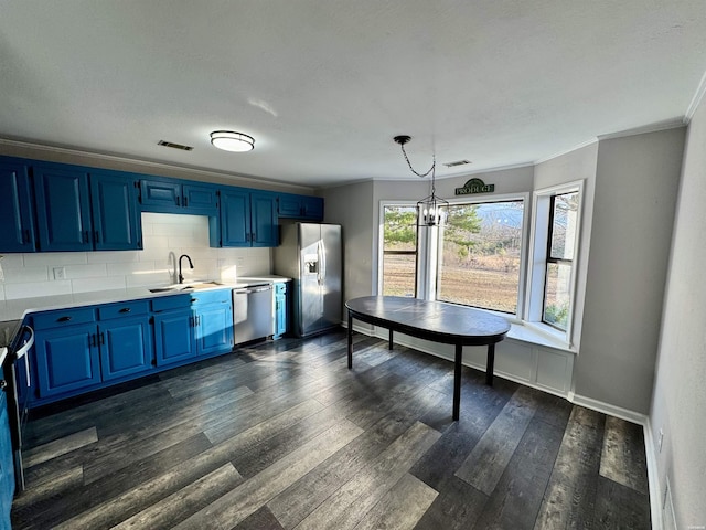 kitchen featuring blue cabinets, stainless steel appliances, visible vents, light countertops, and decorative light fixtures