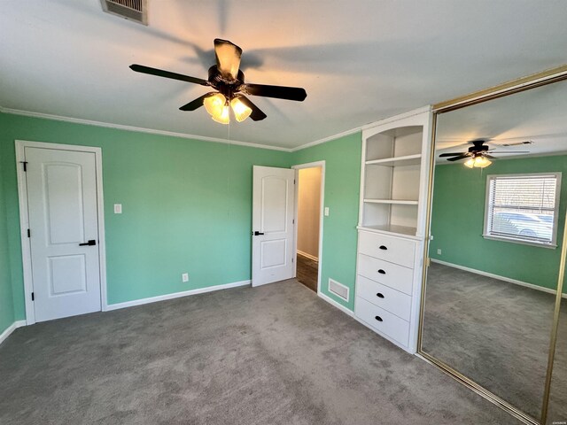 unfurnished bedroom featuring ornamental molding, visible vents, light carpet, and a ceiling fan