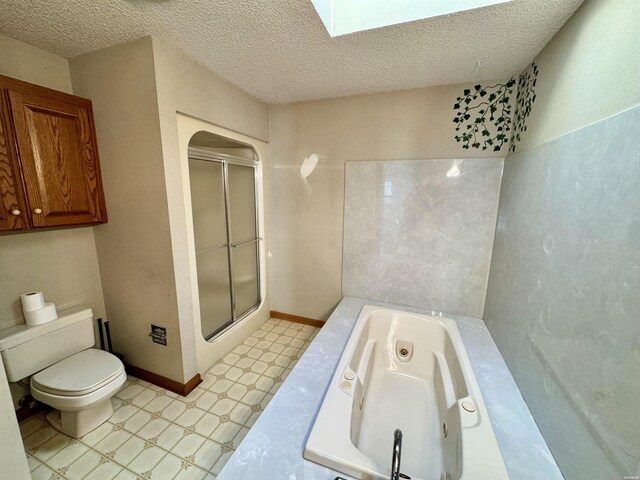 full bath with a skylight, toilet, a shower stall, baseboards, and tile patterned floors