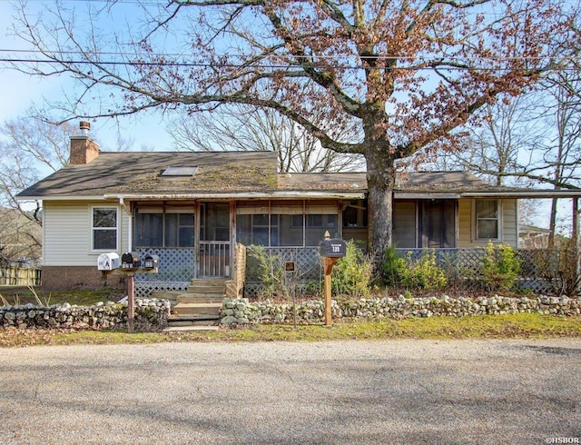 ranch-style house featuring a chimney