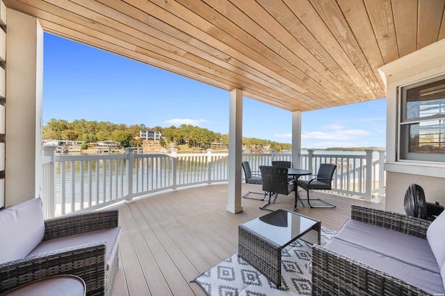 wooden terrace with outdoor lounge area, outdoor dining area, and a water view