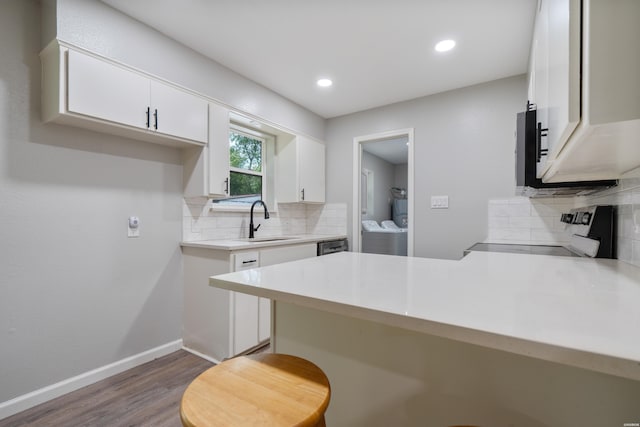 401 Buttrum Rd, Royal, AR 71968 - kitchen featuring appliances with stainless steel finishes, a peninsula, tasteful backsplash, white cabinets, and recessed lighting