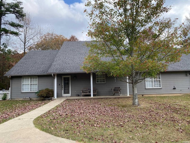 view of front of house featuring a shingled roof and a patio area