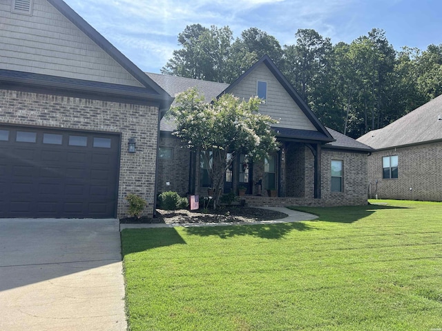 1910 Josh Dr, Conway, AR 72034 - view of front of property featuring brick siding, a front yard, driveway, and a garage