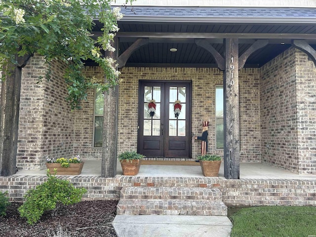 1910 Josh Dr, Conway, AR 72034 - entrance to property with french doors, brick siding, roof with shingles, and covered porch