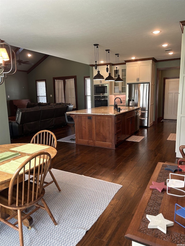 1910 Josh Dr, Conway, AR 72034 - kitchen with appliances with stainless steel finishes, dark wood-style flooring, a kitchen island with sink, glass insert cabinets, and open floor plan