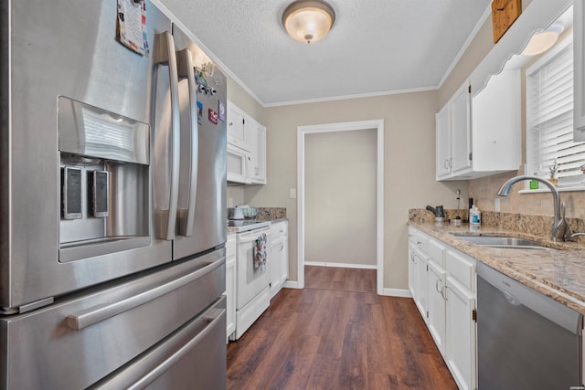 kitchen featuring dark wood-style floors, stainless steel appliances, white cabinets, a sink, and light stone countertops