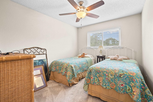 carpeted bedroom with a ceiling fan and a textured ceiling