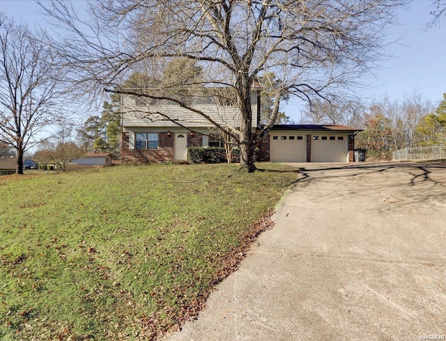 view of front facade featuring a garage, a front yard, concrete driveway, and brick siding