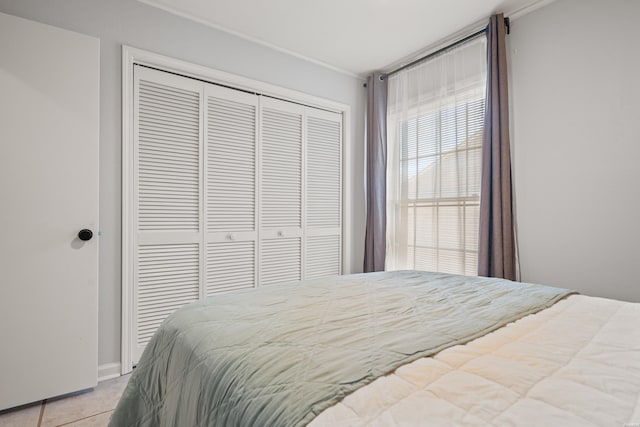 bedroom with a closet and light tile patterned floors