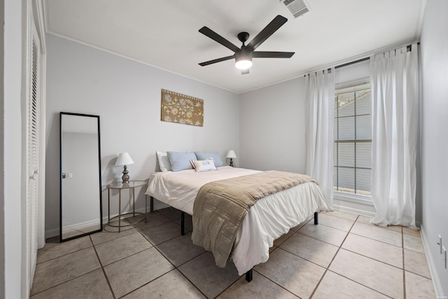 tiled bedroom featuring ceiling fan, baseboards, visible vents, and ornamental molding