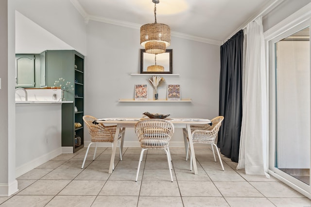 dining space featuring an inviting chandelier, crown molding, light tile patterned flooring, and baseboards