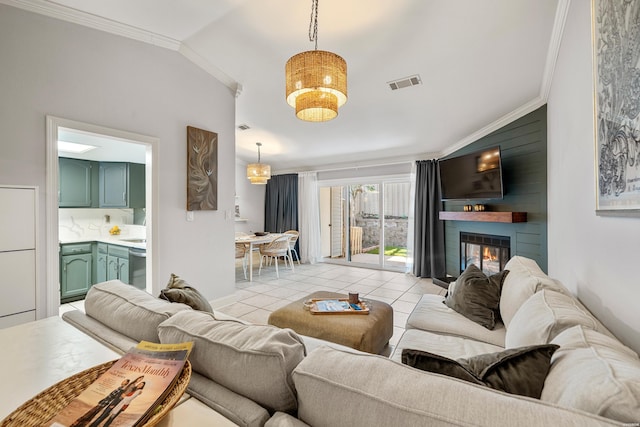 living area featuring a large fireplace, light tile patterned floors, visible vents, and ornamental molding