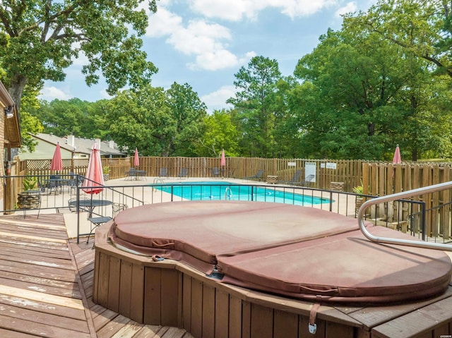 view of pool featuring a fenced in pool, a deck, a covered hot tub, and fence