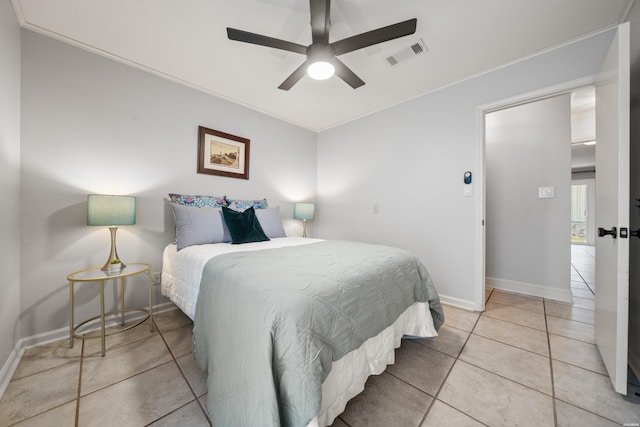 bedroom with visible vents, a ceiling fan, crown molding, light tile patterned floors, and baseboards