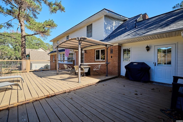 wooden terrace featuring a grill