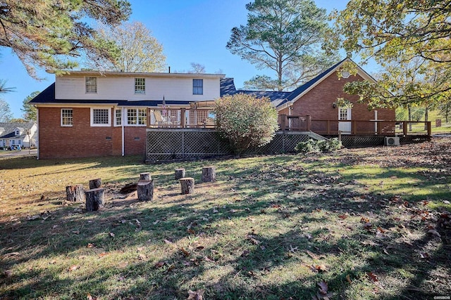 rear view of house with a deck, a yard, brick siding, and crawl space