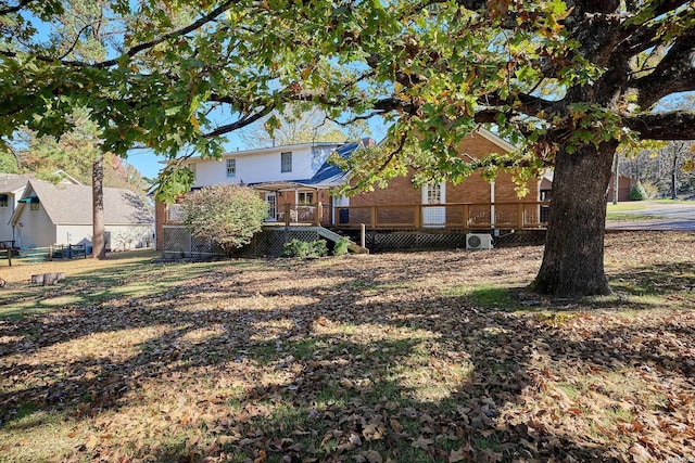 view of yard with fence and a wooden deck