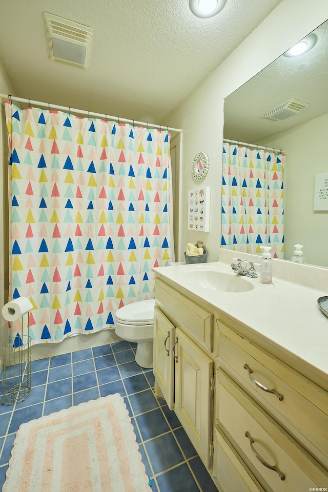 bathroom with toilet, a textured ceiling, visible vents, and tile patterned floors