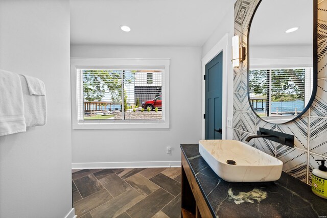 bathroom featuring recessed lighting, vanity, and baseboards