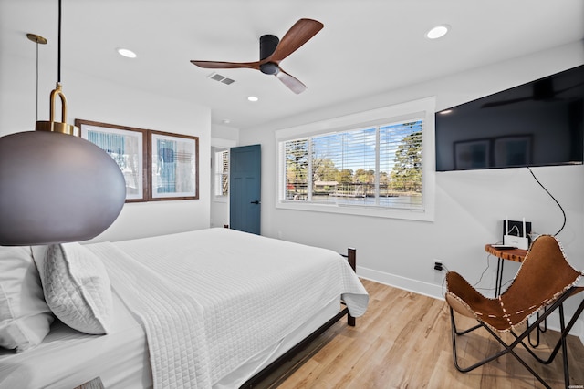 bedroom with recessed lighting, visible vents, light wood-style flooring, and baseboards