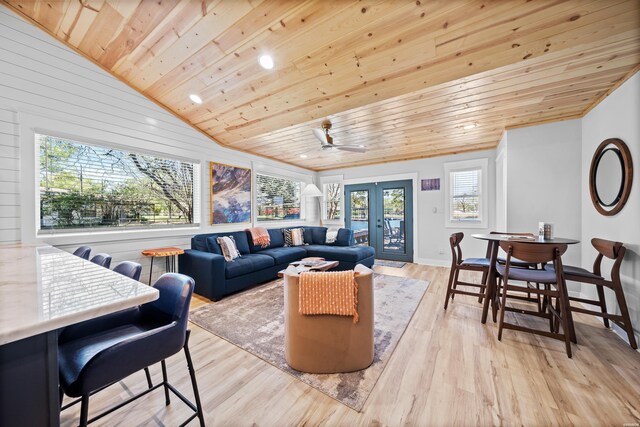 living room featuring light wood-style floors, wood ceiling, vaulted ceiling, and french doors