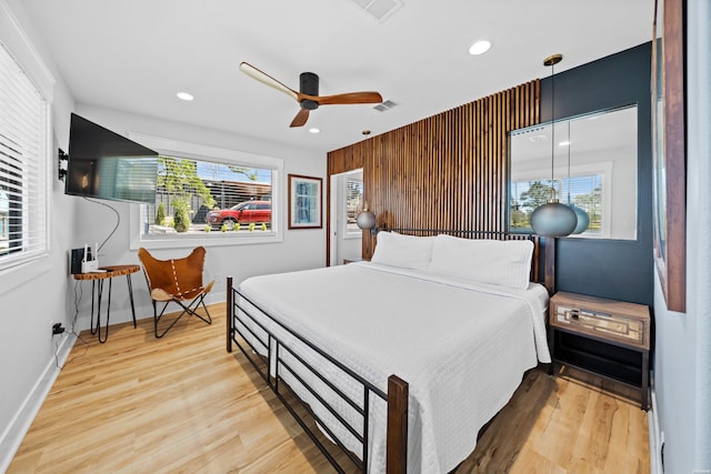 bedroom featuring light wood finished floors, baseboards, visible vents, and recessed lighting