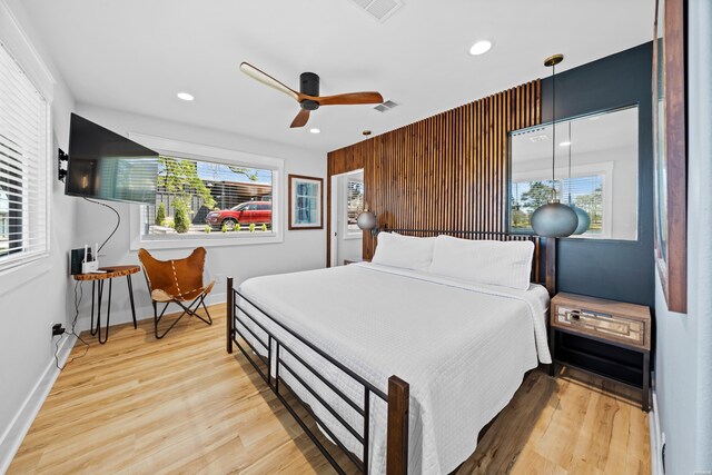 bedroom featuring light wood finished floors, baseboards, visible vents, and recessed lighting